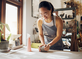 Image showing Happy, pottery and woman in workshop with clay for creativity, inspiration and art process. Creative asian small business girl working at artistic workspace with excited smile in Tokyo, Japan