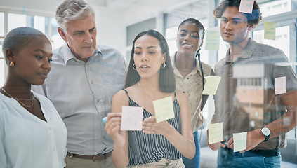 Image showing Innovation, meeting or woman writing on a sticky note planning a startup project on glass board in office building. Focus, leadership or creative business people working on strategy ideas or solution