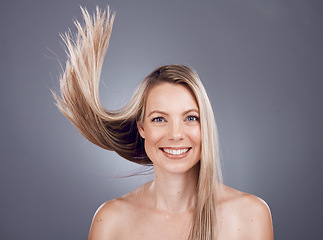 Image showing Portrait, beauty and hair with a model woman in studio on a gray background for keratin treatment or natural haircare. Face, skincare and wellness with a female posing to promote a haircare product