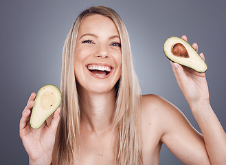 Image showing Portrait, beauty and avocado with a model woman in studio on a gray background for natural treatment. Face, skincare and nutrition with an attractive young female posing to promote skin antioxidants