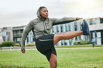 Image showing Fitness, running and stretching with a sports black man getting ready for exercise in a park during summer. Health, workout and start with a male athlete training on grass for cardio or endurance