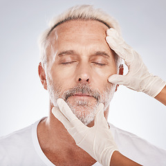 Image showing Man, face or plastic surgeon hands on studio background for skincare collagen, medical help dermatology or anti aging grooming. Zoom, cosmetic surgery or mature patient model in facial change consult