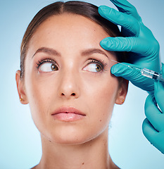 Image showing Plastic surgery, skincare and woman with injection, healthcare and on blue studio background. Female, girl and botox with cosmetics, wellness and face care for health, soft and smooth skin for beauty