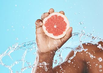 Image showing Water splash, grapefruit in hand and studio background for healthy, vegan and nutrition food on advertising, marketing or promotion mockup. African, shower and juice fruit benefits in clean skincare