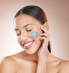 Image showing Face mask, skincare and woman model in a studio for a cosmetic, wellness and natural routine. Cosmetics, beauty and female from Brazil with a charcoal facial treatment isolated by a brown background.