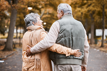Image showing Senior couple, love and health while walking outdoor for exercise, happiness and care at a park in nature for wellness. Old man and woman embrace in a healthy marriage during retirement with freedom