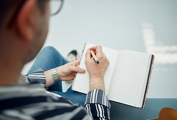 Image showing Top view, man and writing in notebook, planning and focus on schedule, solutions and essay. Male student, academic and writer with diary, journal and pen for studying, creative and thinking with book