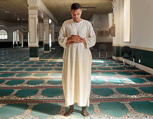 Image showing Man, muslim faith and praying in mosque for God, peace and mindfulness with traditional islamic clothes. Islam worship, prayer and spiritual balance for ramadan, religion and gratitude in Doha, Qatar