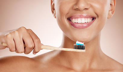 Image showing Woman, cosmetics and brushing teeth for dental hygiene, smile and clean mouth on studio background. Female, girl and tooth brush for oral health, healthcare and fresh breath for natural care or relax