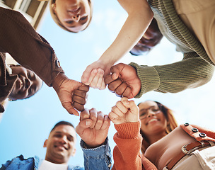 Image showing Group of friends, hands bump in huddle and group diversity, team building circle from below. Friendship, happiness and university students in fist bump, men and women smile together on college campus