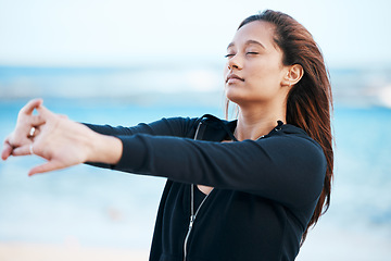 Image showing Young woman stretching on beach, relax on summer holiday and peaceful blue sky in Mauritius. Calm female tourist meditating on seaside, healthy outdoor yoga and girl breathing fresh ocean air