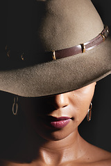 Image showing Woman, dark studio and hat for fashion, beauty and mystery with style, design or closeup headshot. Girl, model and black background for fantasy, night aesthetic or makeup for edgy, sexy woman and art