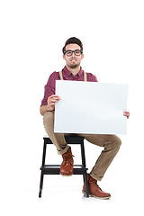 Image showing Man, studio portrait and holding paper board for marketing, branding mockup and focus by white background. Young model, isolated and sitting with mock up poster, billboard and space for advertising