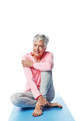 Image showing Senior woman, yoga and portrait in studio isolated on a white background. Zen chakra, pilates fitness and retired female from Canada sitting on training or stretching break for health or wellness.