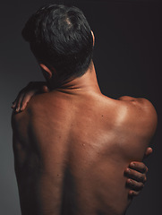 Image showing Hug, self love and back of a man with creative aesthetic, self expression and body on a dark black studio background. Skin embrace, art and mysterious model with love, self care and affection