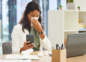 Image showing Business woman, tissue and allergy while using phone and blowing nose while sick with covid or flu virus at corporate desk. Black female entrepreneur with communication app for a health consultation