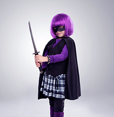 Image showing Girl kid, costume and sword in studio portrait for vigilante fantasy, creative and comic aesthetic. Child, superhero mask and creativity for martial arts, villain cosplay and halloween by background