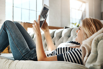 Image showing Woman, tablet and credit card for ecommerce on sofa relaxing in the living room for online purchase at home. Female shopper banking on touchscreen with bank card for purchase, app or sale on couch