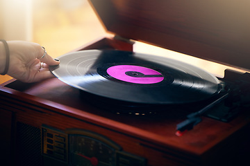 Image showing Record player, hand and woman playing music in home living room. Classic technology, retro and female putting vintage vinyl record in turntable or gramophone to play sound, audio or song in house.