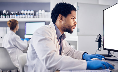 Image showing African scientist man, mock up and computer in research, reading or focus for goals in lab. Black man, science or laboratory with blank desktop pc for vision, healthcare or pharmaceutical mockup