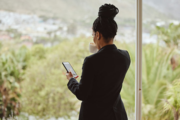 Image showing Phone, coffee and window with a business black woman checking her social media or communication feed in the morning. Mobile, network and tea with a female employee typing or texting by a glass wall