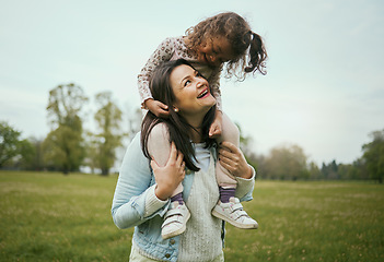 Image showing Park, mother and girl sitting shoulders for happiness, bonding or care on nature walk together in spring. Woman, kid and happy for quality time, love or play on grass field for outdoor fun in Toronto