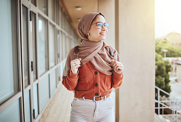 Image showing University, Muslim and campus student walking, happy and relax on journey to class, education learning or lecture study. School, hijab and Islamic woman, college girl or person on walk in Indonesia