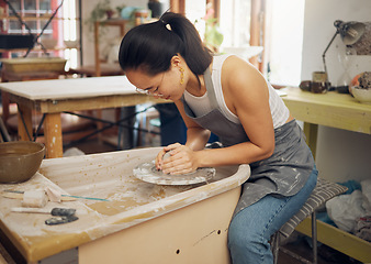 Image showing Clay, pottery or woman in art workshop working on a cup sculpture or mug mold in small business. Focus, artistic girl or Japanese creative designer manufacturing handicraft products as entrepreneur