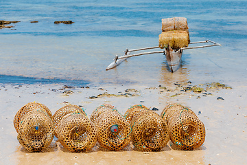 Image showing traditional malagasy fishing boat with trap on beach