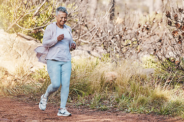 Image showing Running, fitness and senior woman in nature for marathon training, sports health and retirement cardio in Indonesia. Smile, workout and happy elderly runner in a park or mountains for exercise