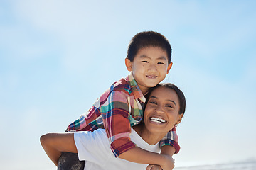 Image showing Mother, beach piggyback and child in portrait, interracial family bonding and outdoor vacation in sunshine. Happy family, asian boy and black woman for adoption, love and ride game on ocean holiday