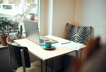 Image showing Laptop, documents and coffee shop with a table and chairs in an empty restaurant for freelance or remote work. Business, cafe and coffee with a pen and paper in a workspace at an internet cafe