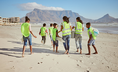 Image showing Woman, children and beach clean up in school accountability learning, climate change collection or sustainability recycling. Kids, students diversity and people in community service or ocean cleaning