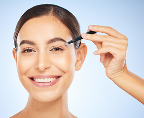 Image showing Beauty, tweezers and portrait of woman on blue background, facial grooming and professional hair removal. Spa, salon and skincare, happy woman plucking or tweezing eyebrows hair.