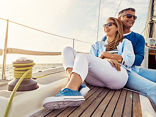 Image showing Smile, happy and couple on a yacht at sea, summer travel and ocean adventure in Spain. Peace, hug and man and woman on a boat for a luxury cruise, sailing and happiness on holiday on the water