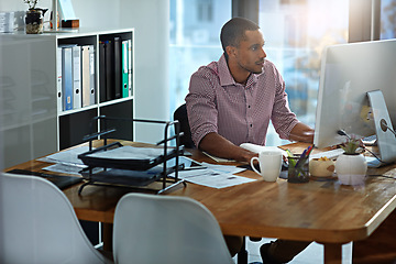 Image showing African businessman, office and reading at computer, focus and planning with vision, goal and start morning with ideas. Corporate black man, pc and notebook for strategy, typing or email on internet