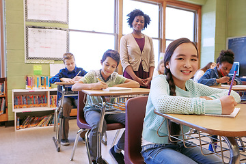 Image showing Learning, teacher and portrait of a girl with a smile to study, writing and test at school. Happy, education and student at a desk for creativity in a classroom, studying notes and knowledge