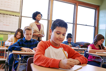 Image showing Children, education or kids in classroom writing in notebook for learning, research or study for exam with teacher. Scholarship, thinking or students happy in school for test, academy or assessment