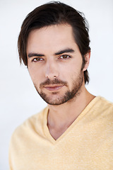 Image showing Portrait, fashion and model with a handsome man in studio on a gray background wearing a t-shirt. Face, style and casual with a young male model posing to promote contemporary or trendy clothes