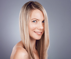 Image showing Portrait, beauty and hair with a model woman in studio on a gray background for keratin treatment or natural haircare. Face, skincare and wellness with a female posing to promote a haircare product