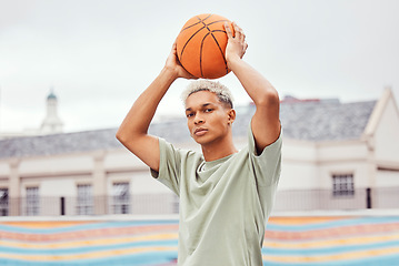 Image showing Basketball, young man and basketball player with sport in park with portrait in city and exercise outdoor. Fitness, athlete on basketball court, focus and urban with sports motivation and training.