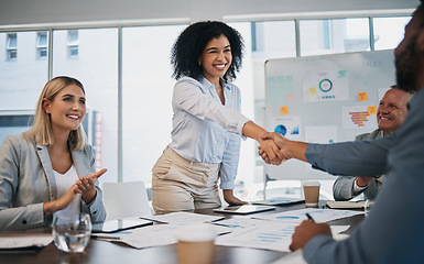 Image showing Business people, woman and handshake at meeting, planning and chart on board for target, success or goal. Corporate finance group, applause and celebration for profit, promotion or vision in New York