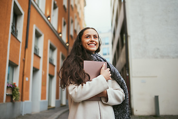 Image showing Travel, tourism and journal with a sightseeing woman tourist in the city traveling for global vacation. Thinking, book and traveling with a young female overseas or abroad for holiday in an urban tow