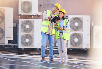 Image showing Tablet, solar energy or engineering team on roof in a city planning, talking or speaking of renewable energy. Solar panels, collaboration or electricians working on photovoltaic development project