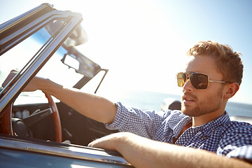 Image showing Car travel, road trip and relax man driving on holiday adventure, transportation journey or fun summer vacation. Lens flare, convertible automobile and driver on outdoor Australia countryside tour