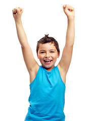 Image showing Children, portrait and winner with a boy in studio isolated on a white background standing arms raised in celebration. Success, wow and kids with a male child raising hands in victory on blank space