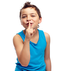 Image showing Portrait, secret and children with a boy standing finger on lips in studio isolated on a white background. Kids, whisper and gossip with a male child on blank space in secrecy or siilence