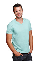 Image showing Portrait, smile and happy man with hands in pocket in studio isolated on a white background. Pride, cool and model male posing in tshirt clothes for trendy style and positive mindset for motivation