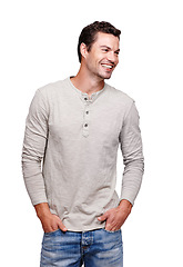Image showing Happy man, laughing and hands in pocket in studio isolated on a white background looking happy. Funny, cool and modern model male thinking and posing in casual clothes for trendy style idea