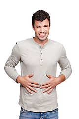 Image showing Hungry, sick and portrait of a man with a stomach problem isolated on a white background in studio. Stress, pain and person with a stomachache, abdominal pain or painful ibs on a studio background